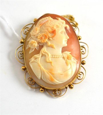 Lot 254 - A cameo brooch within a scroll frame