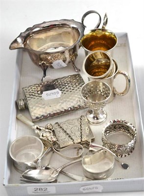 Lot 282 - A silver photograph holder, two mugs, four napkin rings, a menu stand, a rattle, a child's...