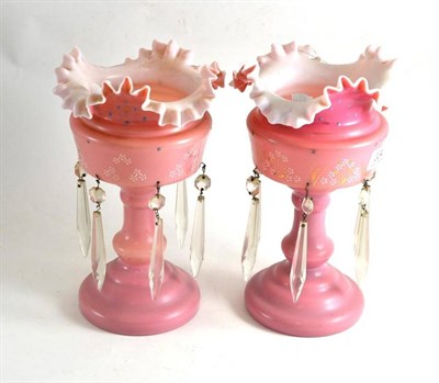 Lot 324 - A pair of Victorian pink glass table lustres with drops