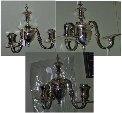 Lot 386 - A set of three plated wall lights