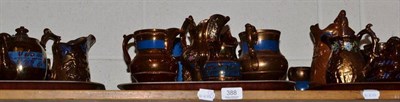 Lot 388 - A quantity of assorted copper lustre jugs, cups, bowls etc (on one shelf)