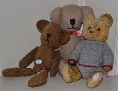 Lot 398 - A 1930's Teddy bear wearing a woollen baby-grow; and two other bears (3)