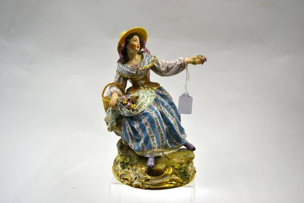 Lot 89 - A Continental Porcelain Figure of a Girl, mid 19th century, in Minton style, seated in a straw...