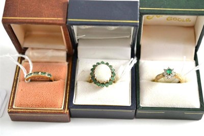 Lot 422 - Two 9ct gold emerald and diamond rings and an opal and emerald cluster ring (3)