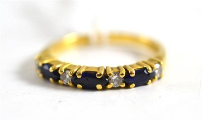 Lot 445 - An 18ct gold sapphire and diamond half eternity ring