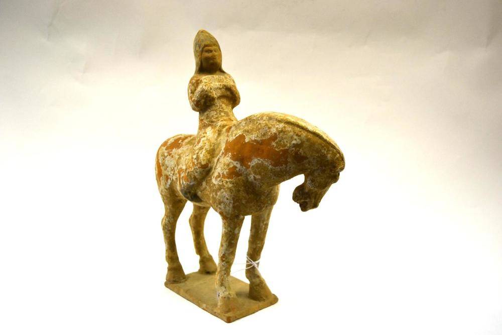 Lot 97 - A Chinese Pottery Figure of a Horse, probably Tang Dynasty, standing four square with musician...