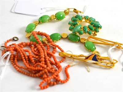 Lot 533 - Two Chinese tie clips, one with enamel yacht, coral necklaces and green stone set brooch and...