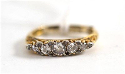 Lot 535 - Five stone diamond ring, further enhanced with diamond chips, in yellow gold