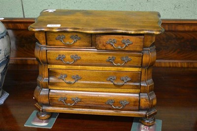 Lot 571 - A miniature chest of drawers