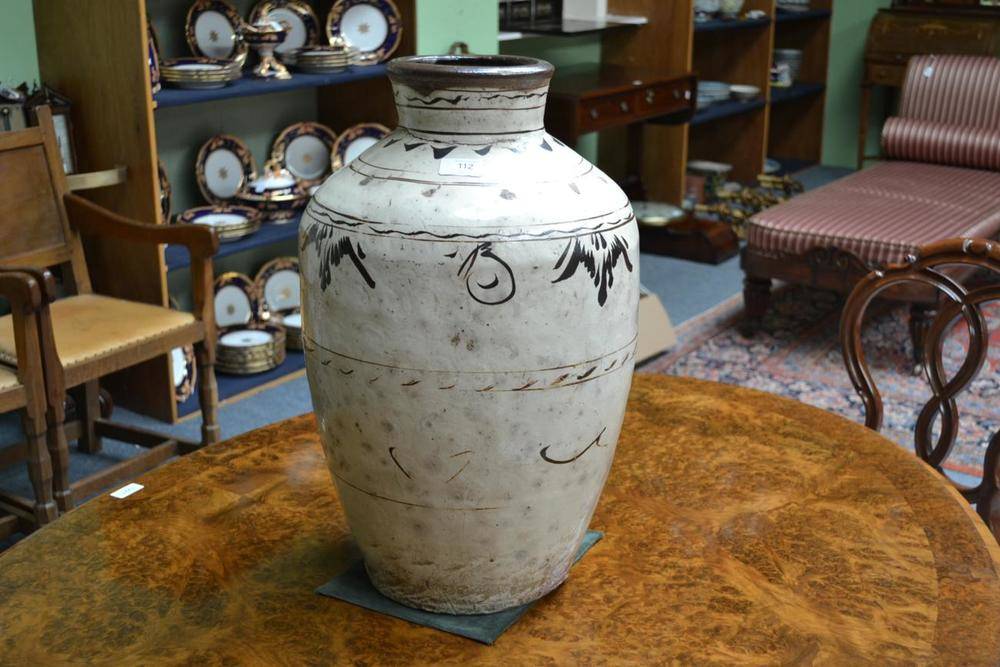 Lot 112 - A Chinese Chizou Slip Glazed Wine Jar, possibly late Ming Dynasty, of baluster form with...