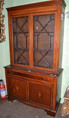 Lot 658 - An Edwardian inlaid mahogany bookcase with cupboard base