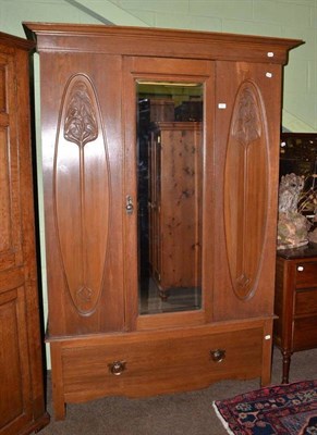 Lot 664 - Arts & Crafts carved oak mirror door wardrobe