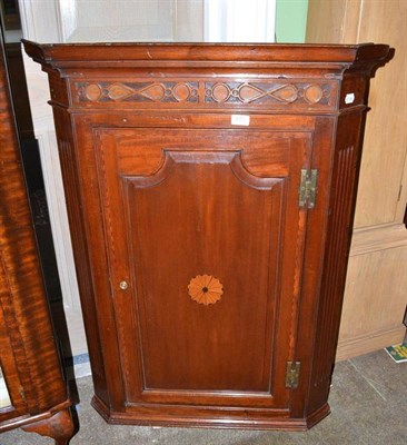 Lot 673 - An 18th century oak hanging corner cupboard with fluted stiles