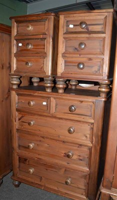 Lot 679 - A modern pine four height chest of drawers and a pair of three drawer bedside tables