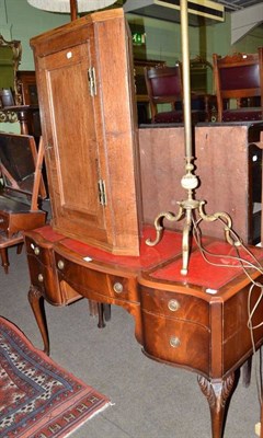 Lot 687 - A reproduction mahogany writing table, oak corner cupboard and standard lamp