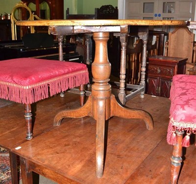 Lot 696 - A George III tripod table with circular flip top