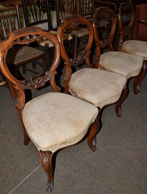 Lot 720 - A set of four Victorian walnut balloon back chairs