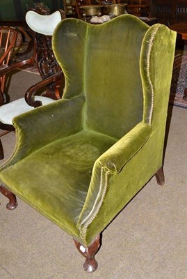 Lot 732 - Late Victorian green velvet upholstered wing back armchair bearing a plate 'Robertson & Colman,...