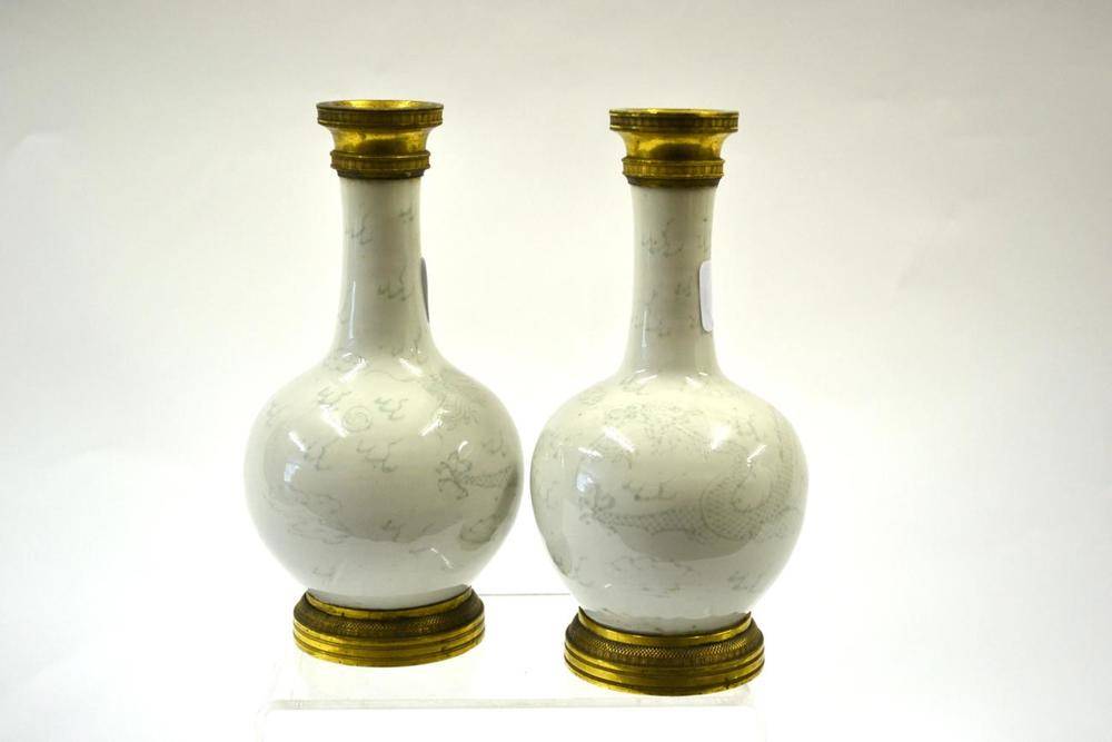 Lot 120 - A Pair of Late 18th Century Chinese Porcelain Bottle Vases, with Empire mounts, incised with...