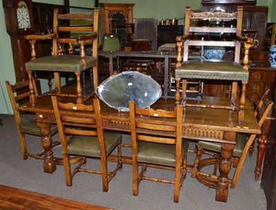 Lot 745 - A reproduction refectory style table and six carved oak dining chairs and two carvers (9)