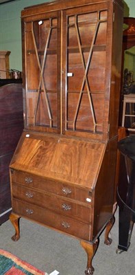 Lot 767 - A reproduction walnut bureau bookcase