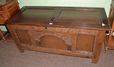 Lot 784 - A joined oak chest with carved frieze and panels