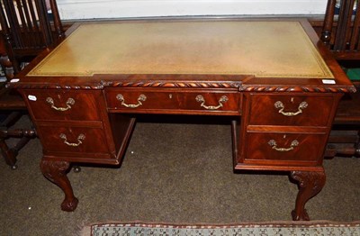 Lot 805 - A reproduction oak desk with ball and claw feet