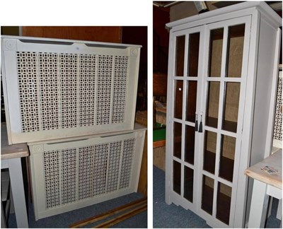 Lot 824 - A modern grey painted two door glazed cabinet and two pierced radiator covers