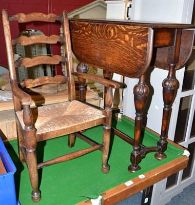 Lot 833 - Small oak drop leaf table, a rush seated child's chair and a signed limited edition framed print of