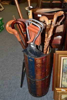 Lot 846 - Quantity of walking sticks including a shooting stick in an umbrella stand mounted with faux...