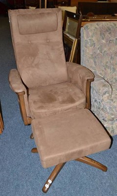 Lot 856 - Ercol reclining chair and a matching stool