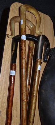 Lot 967 - Four assorted shepherd's crooks with cream and black horn handled mounts