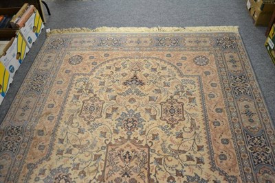 Lot 979 - Machine made rug of Oriental design the ivory field with central medallion, 303cm by 200cm