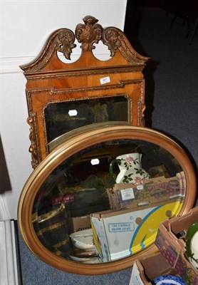 Lot 981 - A decorative walnut framed wall mirror and two oval framed mirrors