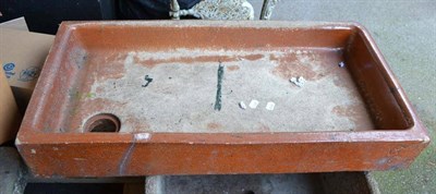 Lot 987 - A brown stoneware trough/sink and a reclaimed stone trough to cover a manhole