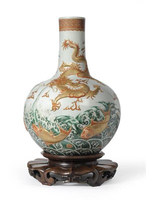 Lot 145 - A Chinese Bottle Vase, 19th century, vigorously decorated in relief with a dragon and carp...