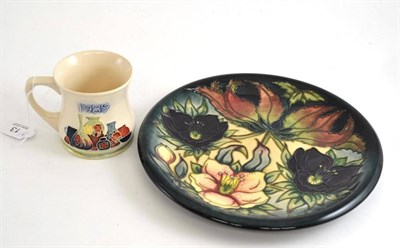 Lot 13 - A William John Moorcroft 'Hellebore' plate and a Moorcroft 1989 museum mug (2)