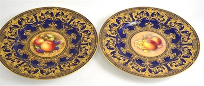 Lot 34 - A boxed pair of Royal Worcester cabinet plates painted with fruits within gros bleu and gilt...