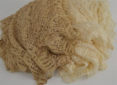 Lot 47 - A cream hand knitted fine shawl and another similar in dark cream (2)