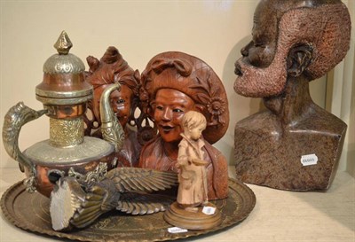 Lot 82 - Carved stone head, an eagle, a pair of carved hardwood heads, a brass tray and a copper teapot