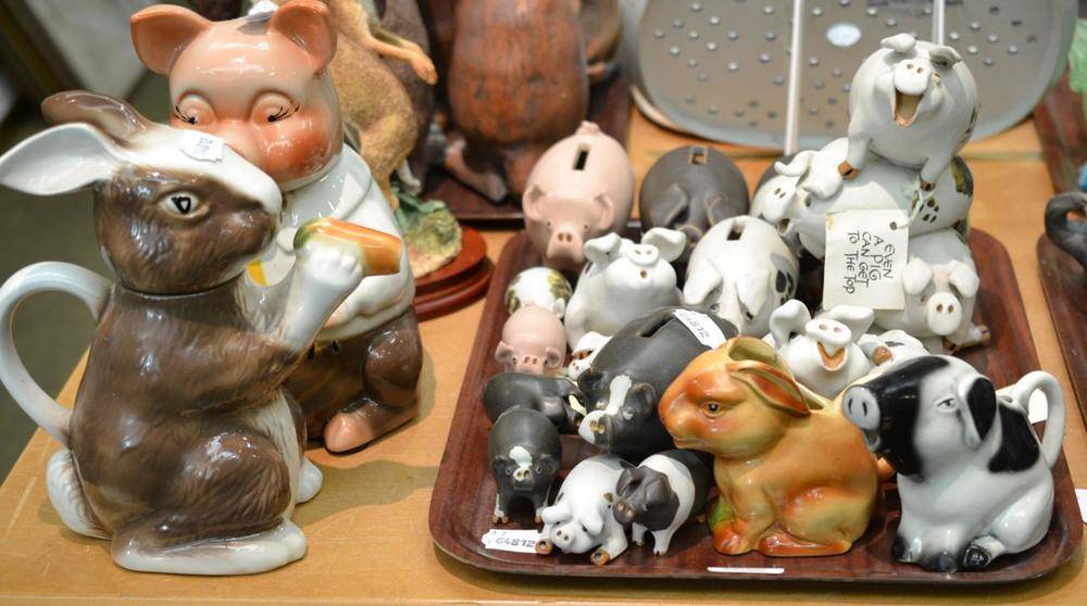 Lot 105 - Tony Wood pig biscuit jar and cover, a rabbit teapot and cover, collection of pottery pigs of...