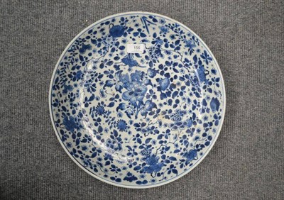 Lot 156 - A Chinese Porcelain Saucer Dish, 18th century, painted in underglaze blue with scattered...