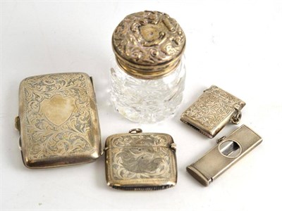 Lot 138 - A silver cigar cutter, two silver vesta cases, a cigarette case and a toilet jar with silver cover