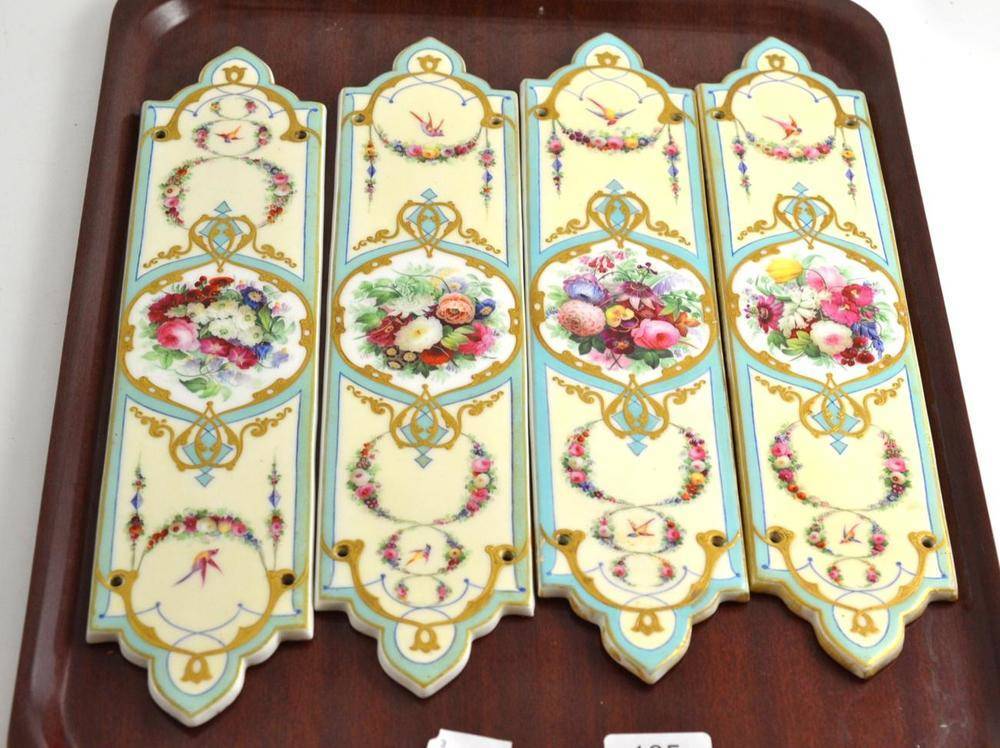 Lot 165 - A set of four Edwardian painted porcelain door plates, each decorated with floral vignettes and...
