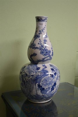 Lot 162 - A Chinese Porcelain Double Gourd Vase, late 19th century, painted in underglaze blue with...