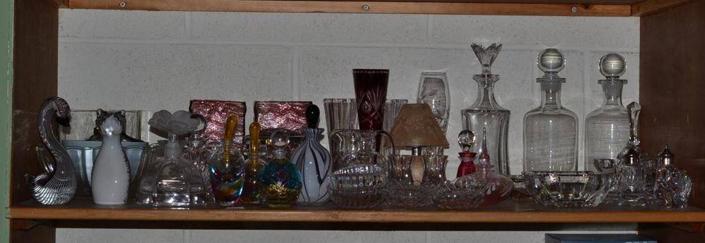 Lot 213 - A shelf including assorted modern glass scent bottles and stoppers, ornaments, decanters,...