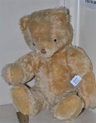 Lot 217 - A yellow plush jointed Teddy bear with growler
