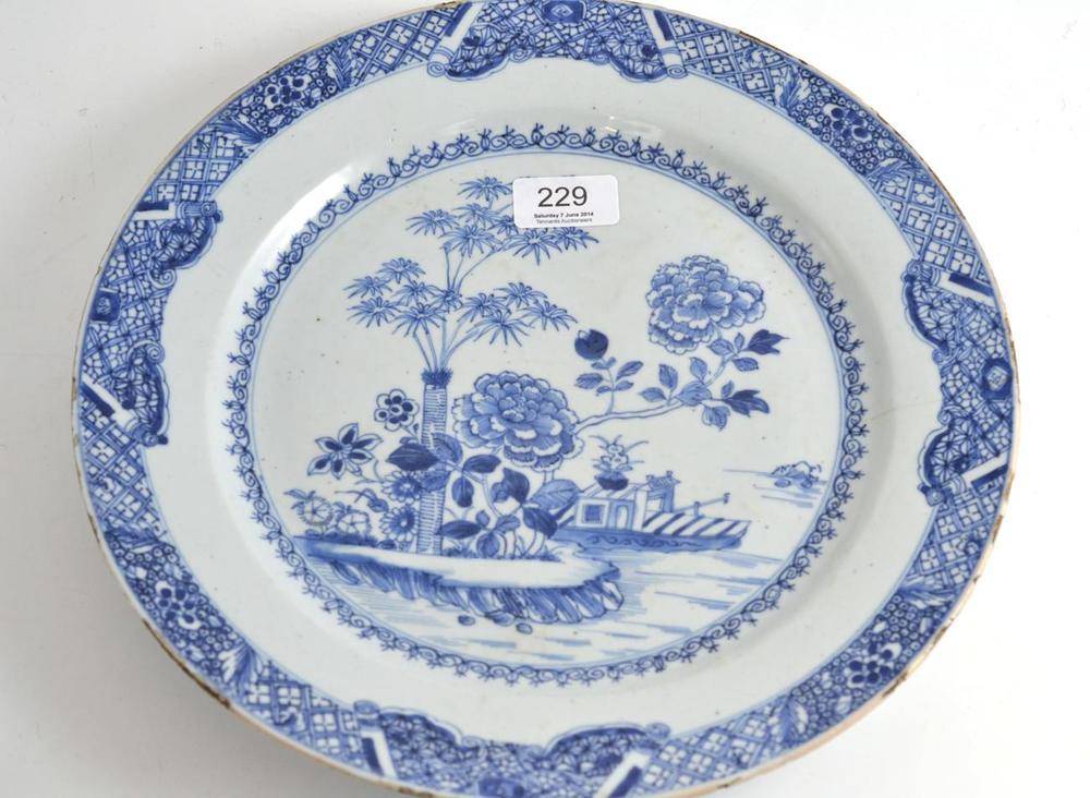 Lot 229 - An 18th century Chinese plate decorated with bamboo and flowers (hairline crack)
