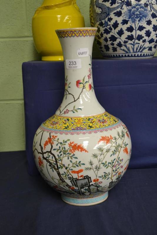 Lot 233 - A Chinese bottle vase decorated with polychrome enamels depicting flowering blossom and a band...