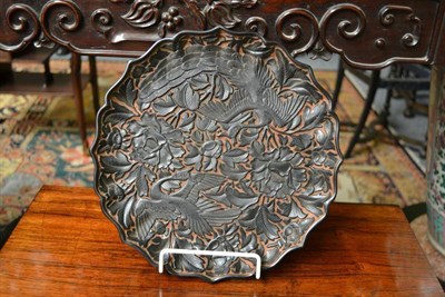 Lot 171 - A Chinese Black and Red Lacquer Dish, in Ming Dynasty style, carved in relief with phoenix...